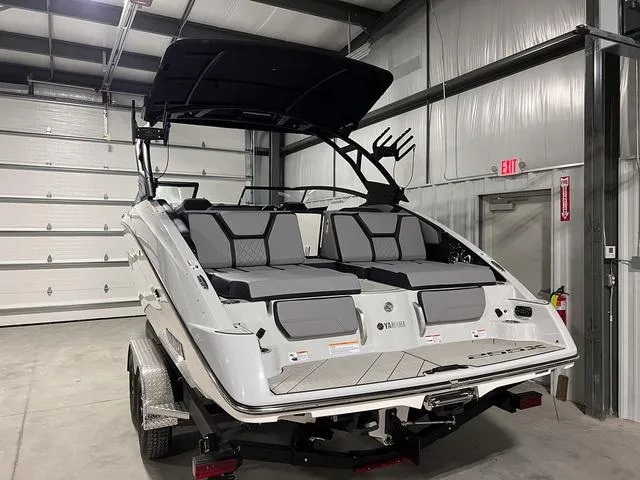 Slide: The Image of 2024 Yamaha Boats 255XE in a garage, showcasing sleek design and modern features. - 4