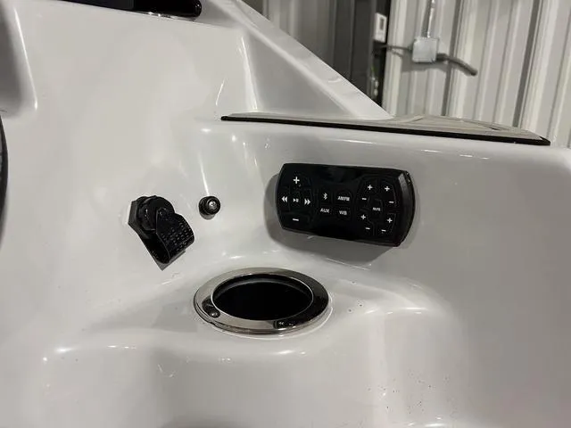 Slide: The Image of 2024 Yamaha Boats 255XE dashboard with control panel and cup holder. - 6