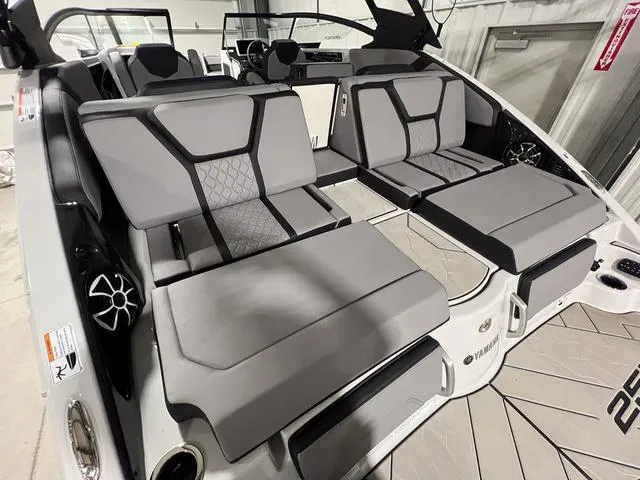 Slide: The Image of 2024 Yamaha Boats 255XE interior with modern gray seating and sleek design. - 7