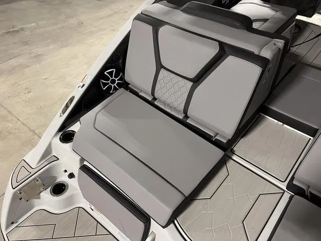 Slide: The Image of 2024 Yamaha Boats 255XE interior seating with modern design and gray upholstery. - 8