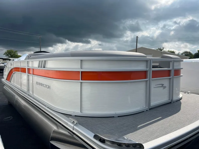 Slide: The Image of 2025 Bennington 21 SXSB pontoon boat with orange and white exterior. - 2
