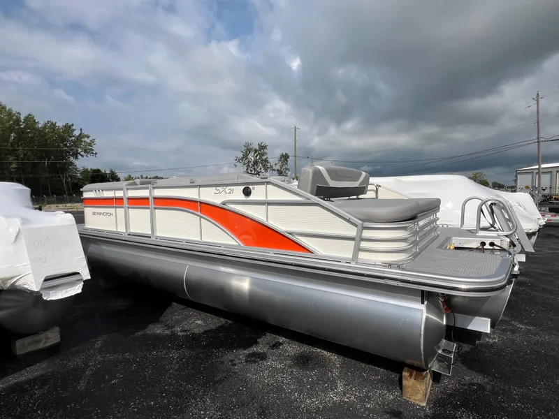 Slide: The Image of 2025 Bennington 21 SXSB pontoon boat with orange and white design. - 3