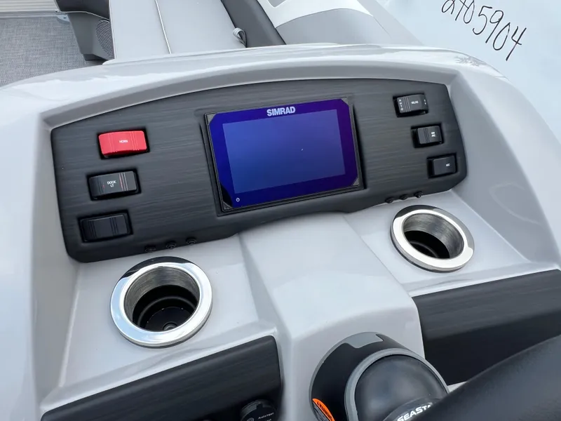 Slide: The Image of 2025 Bennington 21 SXSB boat dashboard with Simrad display and cup holders. - 4