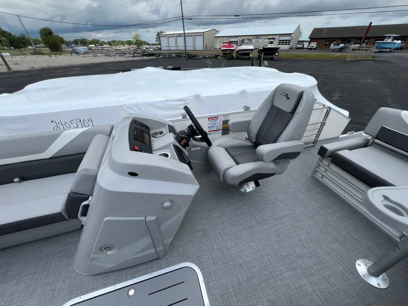 Slide: The Image of 2025 Bennington 21 SXSB boat interior with captain's chair and control console. - 5