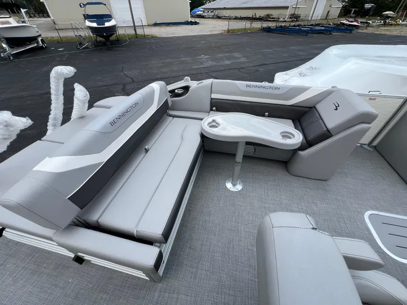 Slide: The Image of 2025 Bennington 21 SXSB pontoon boat interior with gray seating and table. - 6
