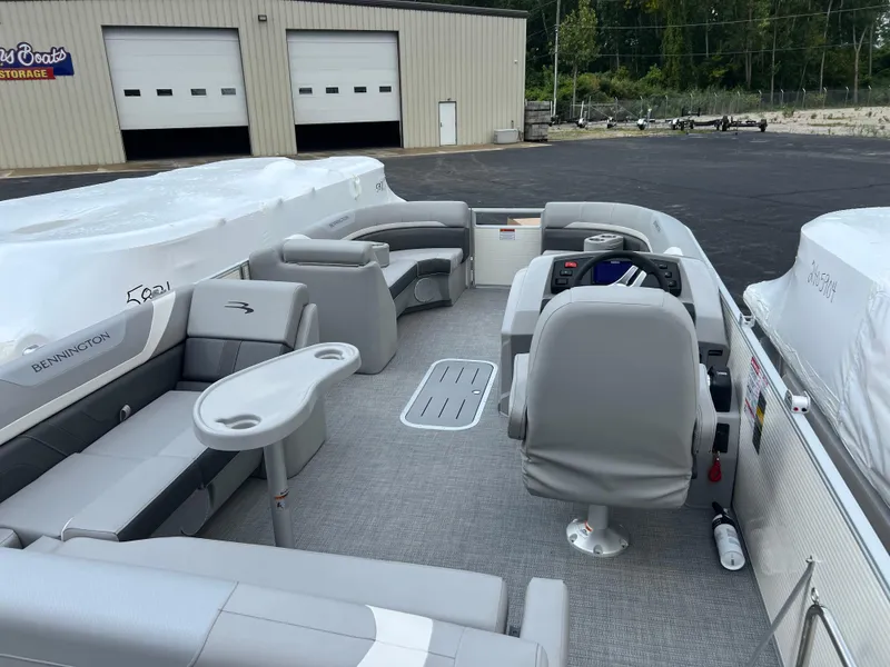 Slide: The Image of 2025 Bennington 21 SXSB pontoon boat interior with gray seating and helm. - 7