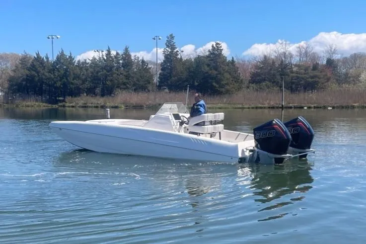 Slide: The Image of 2025 Hustler 25 C3 Speedfish boat on calm water with dual outboard engines. - 11