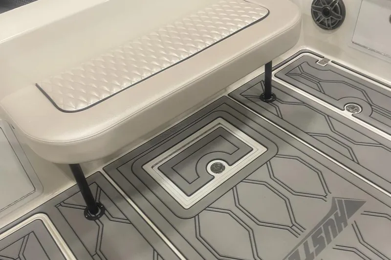 Slide: The Image of 2025 Hustler 25 C3 Speedfish boat interior with cushioned seat and patterned flooring. - 13