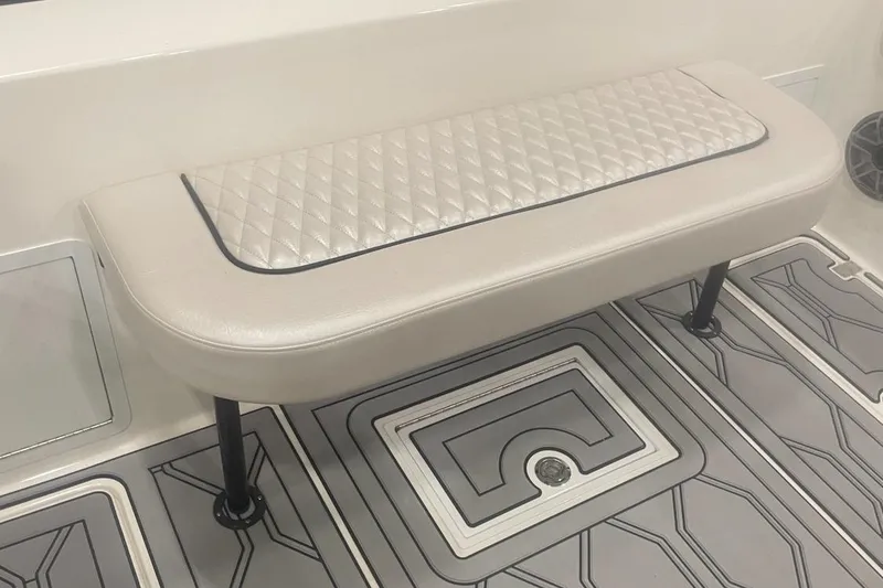 Slide: The Image of 2025 Hustler 25 C3 Speedfish boat interior with cushioned bench seat and patterned flooring. - 15