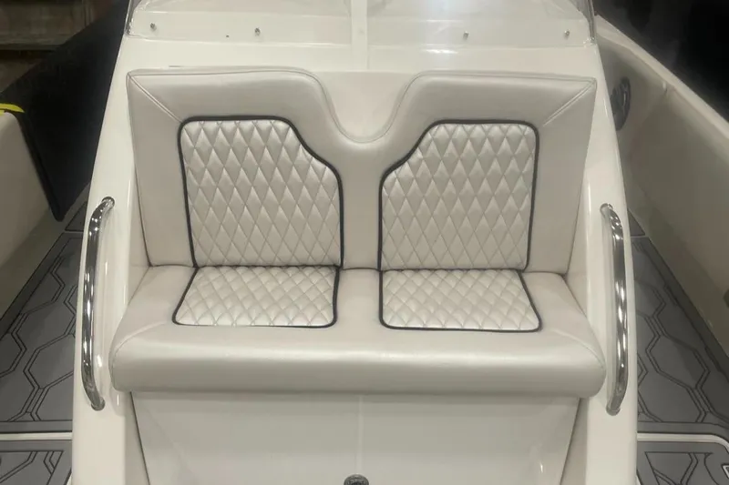 Slide: The Image of 2025 Hustler 25 C3 Speedfish boat with white diamond-stitched seating and chrome handles. - 17