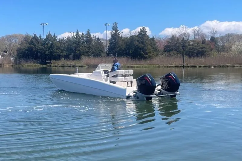 Slide: The Image of 2025 Hustler 25 C3 Speedfish boat cruising on a calm lake. - 20