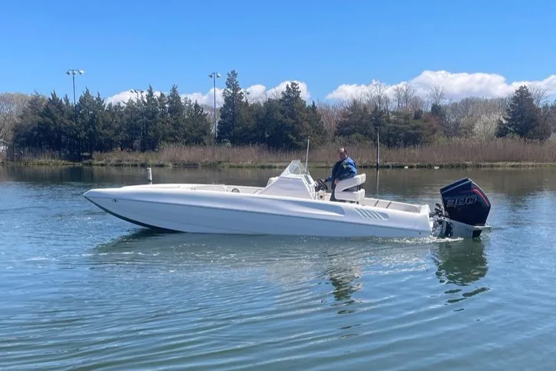 Slide: The Image of 2025 Hustler 25 C3 Speedfish boat cruising on a calm lake. - 21