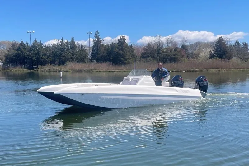 Slide: The Image of 2025 Hustler 25 C3 Speedfish boat cruising on a calm lake. - 22