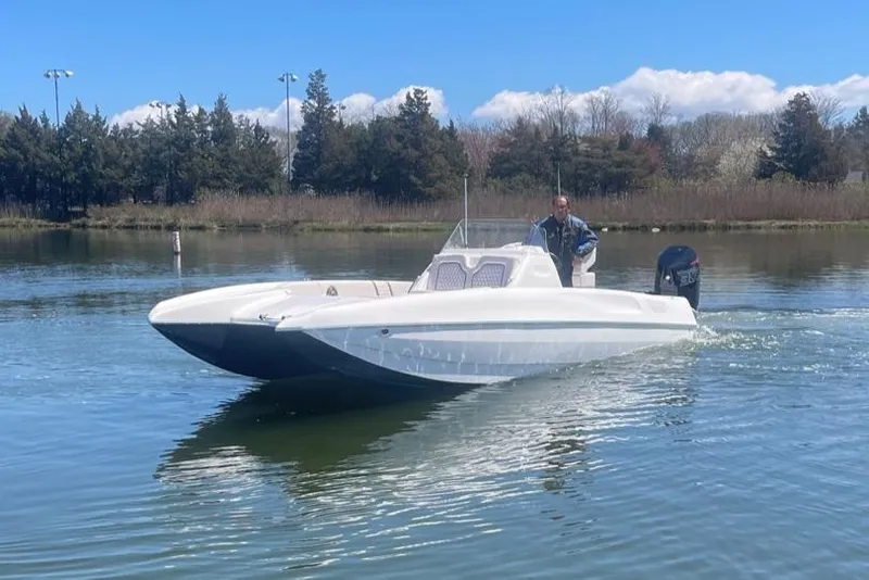 Slide: The Image of 2025 Hustler 25 C3 Speedfish boat cruising on a calm lake. - 23