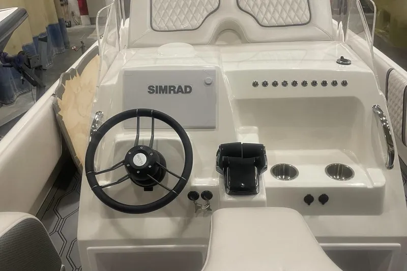 Slide: The Image of 2025 Hustler 25 C3 Speedfish boat dashboard with Simrad navigation system. - 25