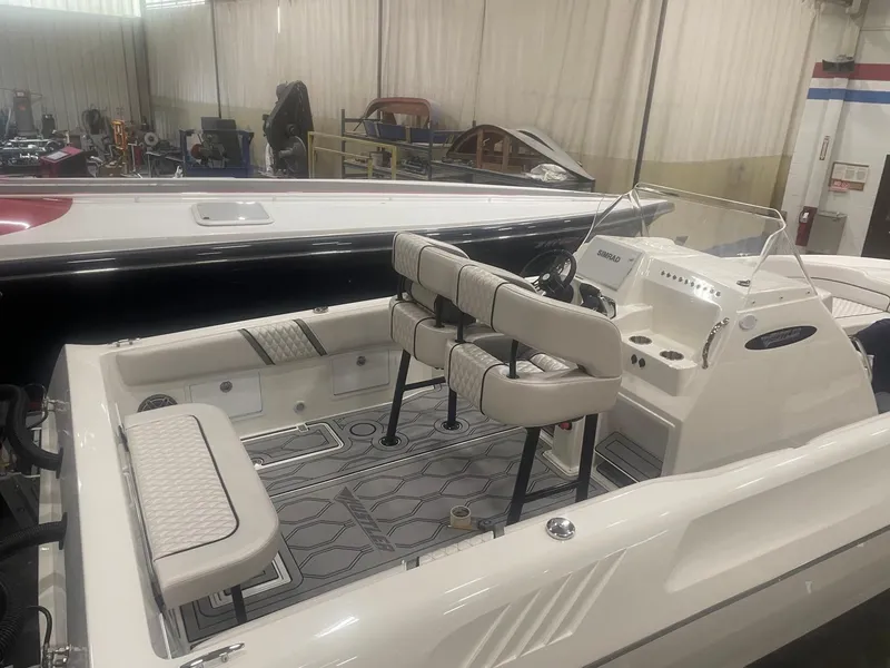 Slide: The Image of 2025 Hustler 25 C3 Speedfish boat interior in a showroom. - 4