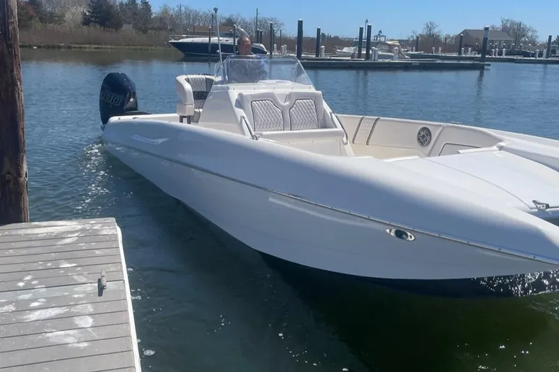 Slide: The Image of 2025 Hustler 25 C3 Speedfish boat docked in a marina. - 8