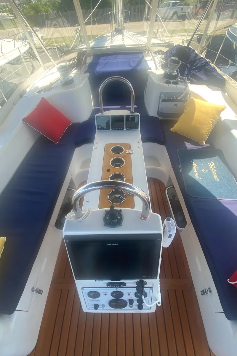 Slide: The Image of 2007 Catalina 470 sailboat cockpit with cushions and steering wheel. - 12