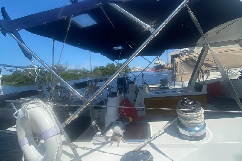 Slide: The Image of Catalina 470 sailboat, 2007 model, docked with visible deck and canopy. - 2