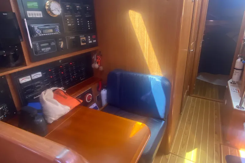 Slide: The Image of Interior of 2007 Catalina 470 sailboat with navigation station and seating area. - 26