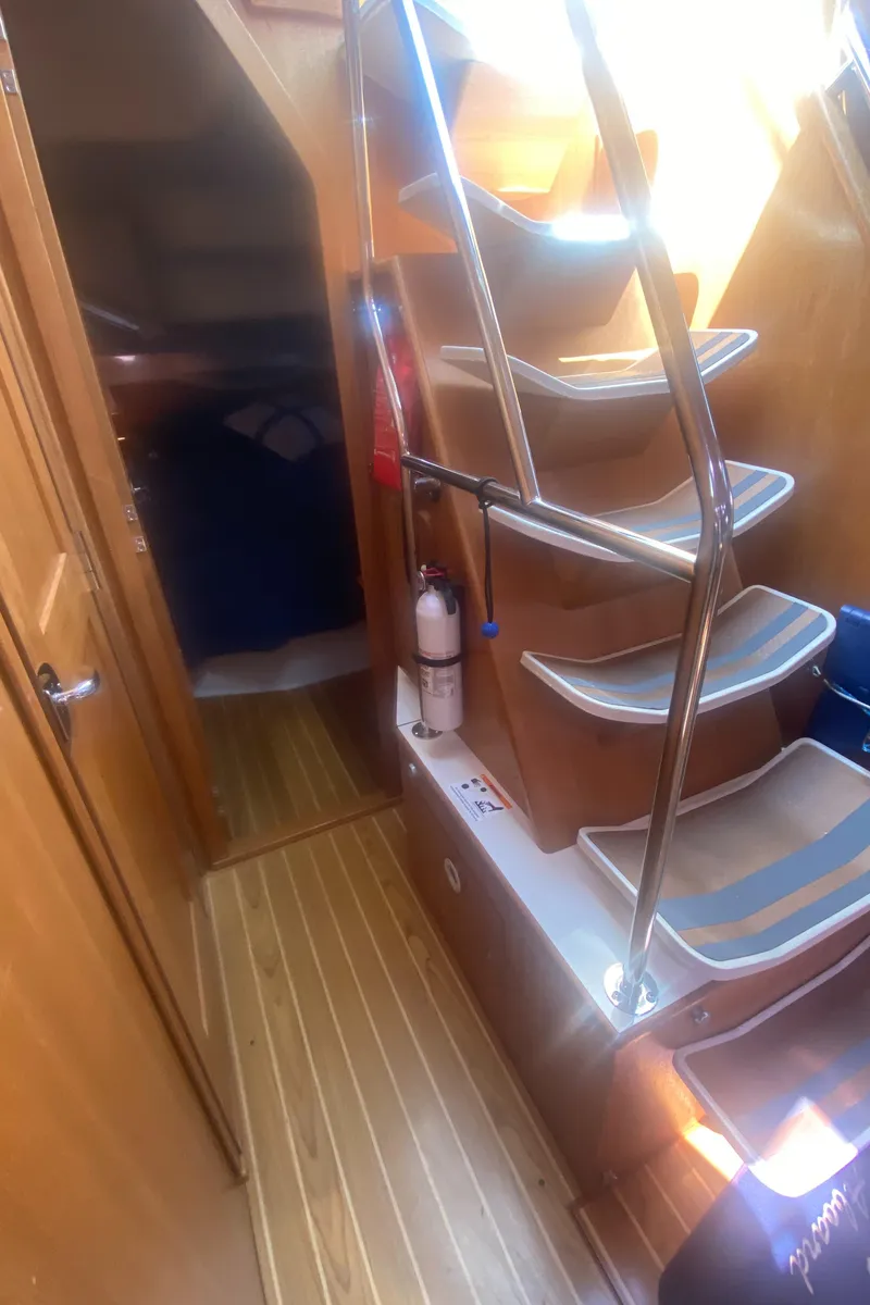 Slide: The Image of Interior of 2007 Catalina 470 yacht with wooden flooring and staircase. - 28