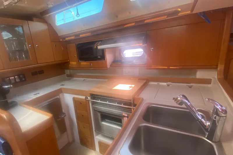 Slide: The Image of Catalina 470 yacht kitchen interior, 2007 model, featuring wood cabinetry and modern appliances. - 29