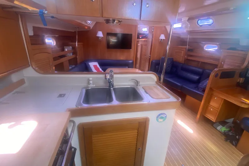 Slide: The Image of Interior of 2007 Catalina 470 yacht with kitchen and seating area. - 32