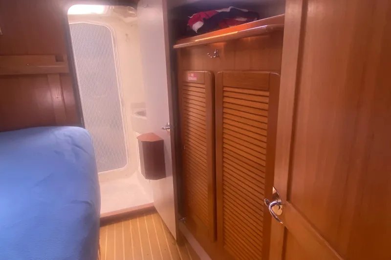 Slide: The Image of Interior of 2007 Catalina 470 yacht with wooden cabinetry and cozy sleeping area. - 36