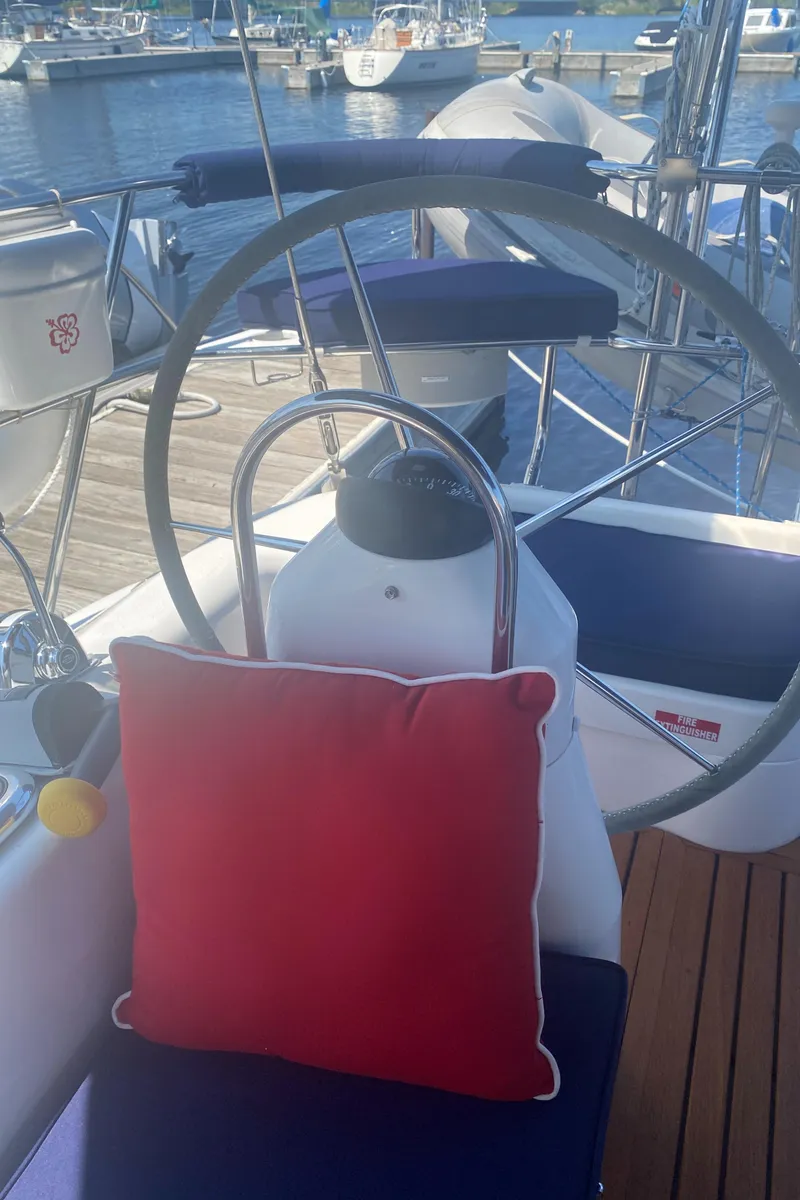 Slide: The Image of 2007 Catalina 470 yacht cockpit with red cushion and steering wheel at marina. - 8