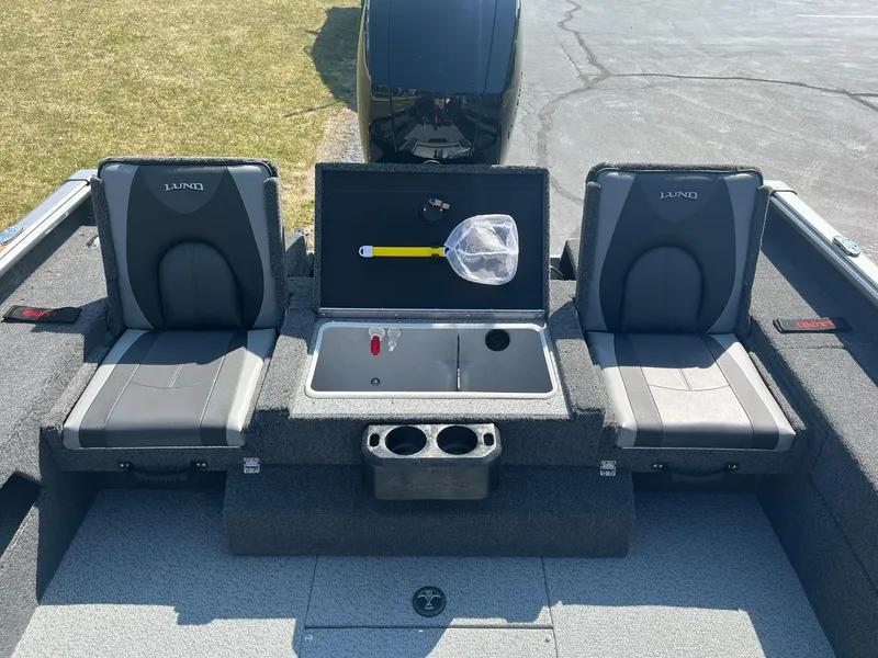 Slide: The Image of 2025 Lund 1875 Impact XS Sport boat interior with seating and storage compartments. - 10