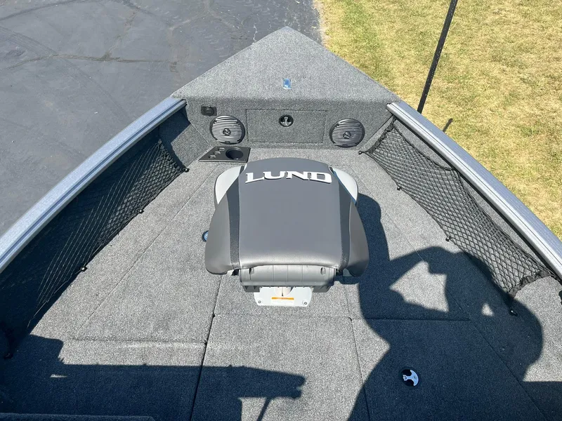 Slide: The Image of 2025 Lund 1875 Impact XS Sport boat interior with seating and storage. - 12