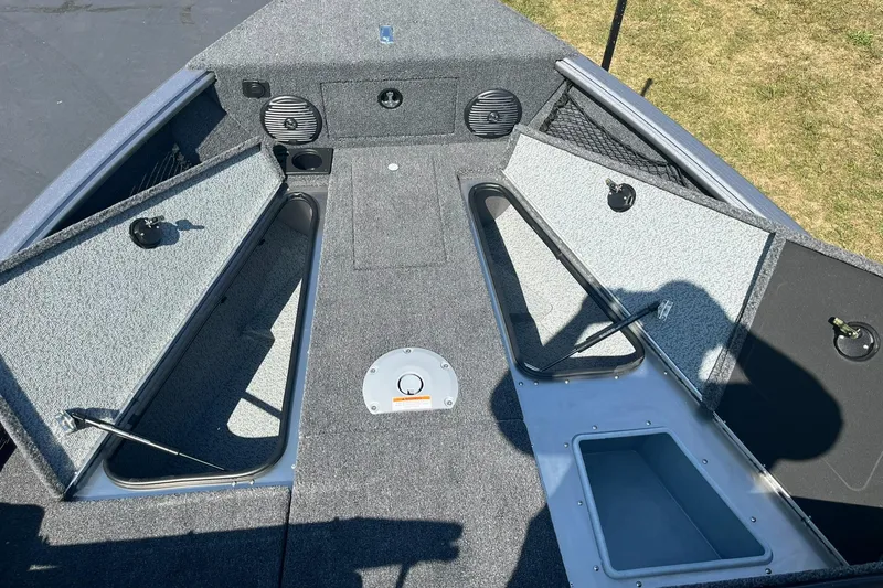 Slide: The Image of 2025 Lund 1875 Impact XS Sport boat interior with open storage compartments. - 14