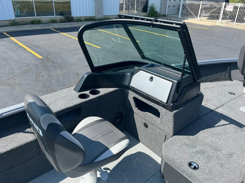 Slide: The Image of 2025 Lund 1875 Impact XS Sport boat interior with seating and console. - 18