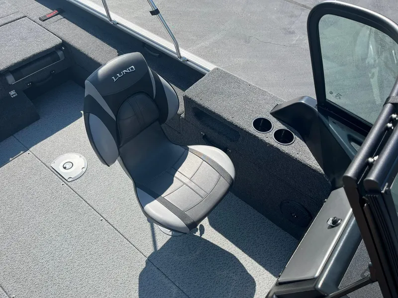 Slide: The Image of 2025 Lund 1875 Impact XS Sport boat interior with seating and cup holders. - 19