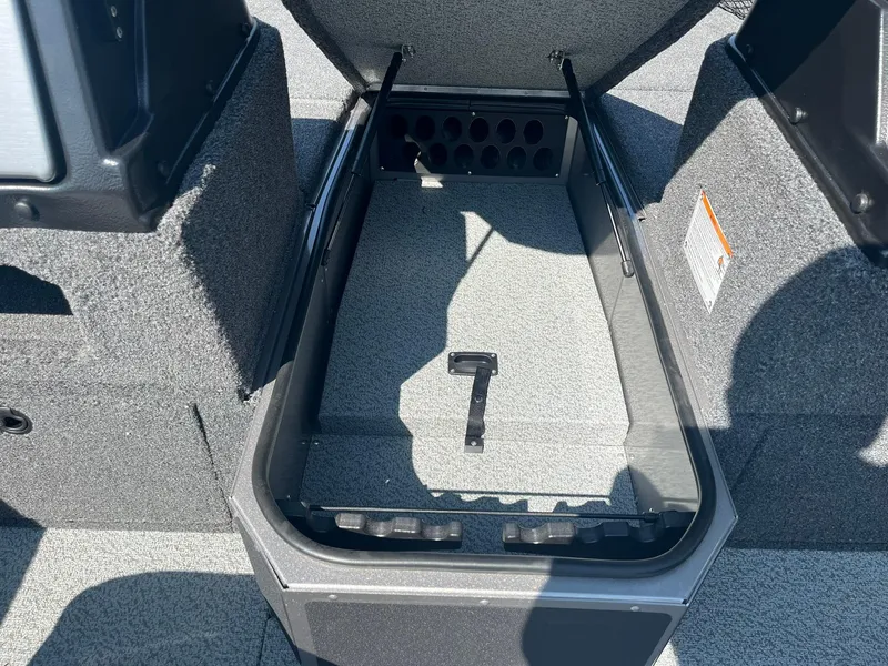 Slide: The Image of 2025 Lund 1875 Impact XS Sport boat storage compartment with open lid. - 21