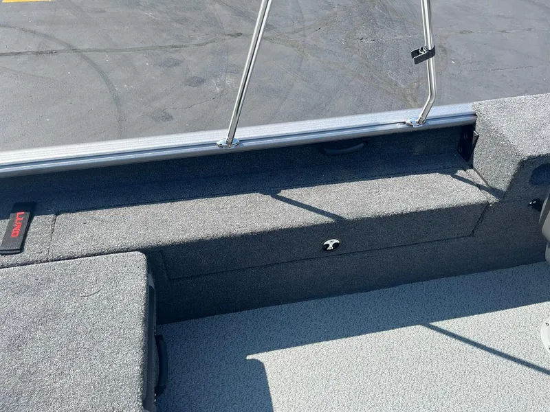 Slide: The Image of 2025 Lund 1875 Impact XS Sport boat interior with gray seating and storage. - 22