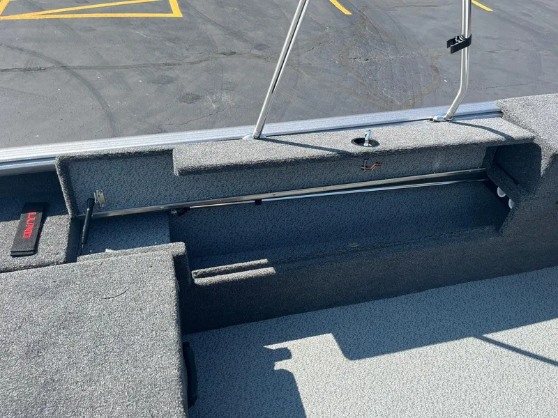 Slide: The Image of 2025 Lund 1875 Impact XS Sport boat interior with storage compartment. - 23