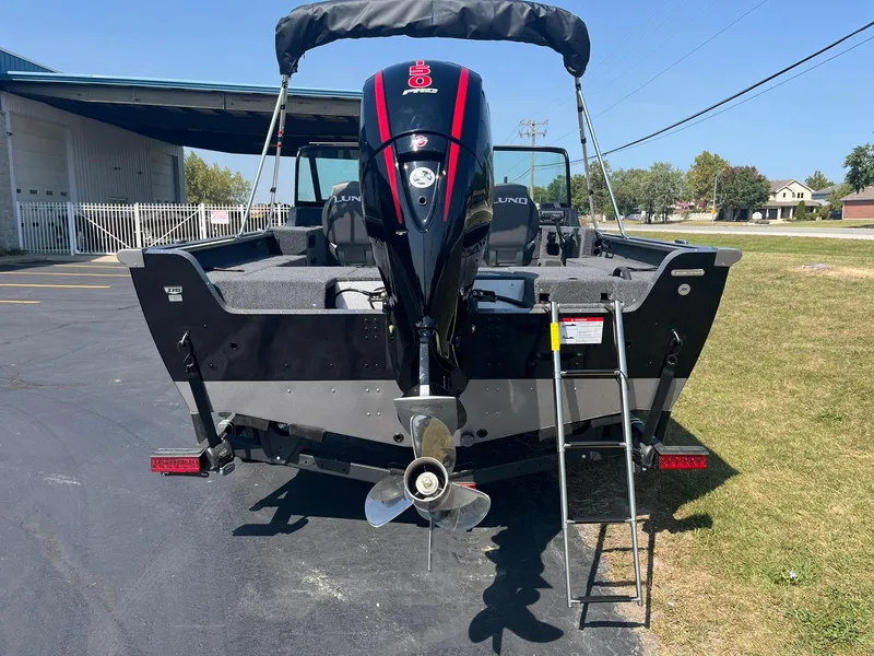 Slide: The Image of 2025 Lund 1875 Impact XS Sport boat, rear view with motor and ladder. - 4