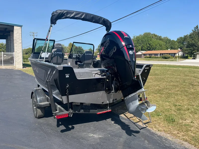 Slide: The Image of 2025 Lund 1875 Impact XS Sport boat with outboard motor on trailer. - 5