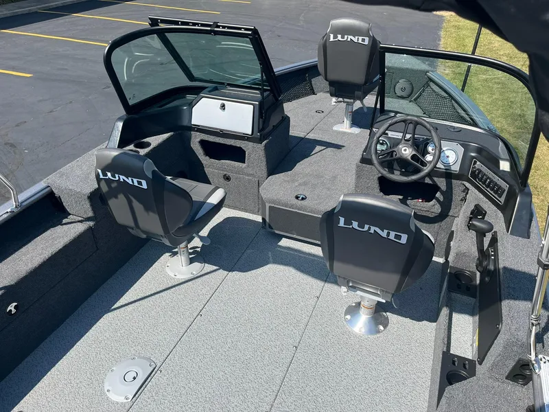 Slide: The Image of 2025 Lund 1875 Impact XS Sport boat interior with seating and steering console. - 7