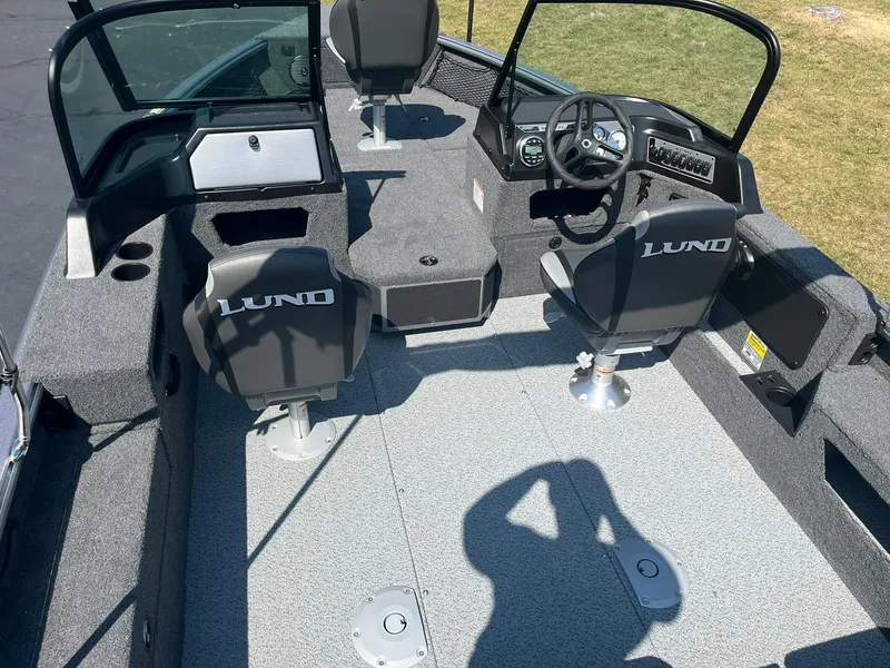 Slide: The Image of 2025 Lund 1875 Impact XS Sport boat interior with seating and steering console. - 8