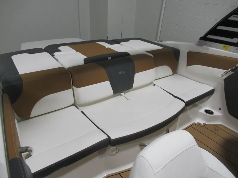 Slide: The Image of 2024 Chaparral 21 SSi boat interior with brown and white cushioned seating. - 5