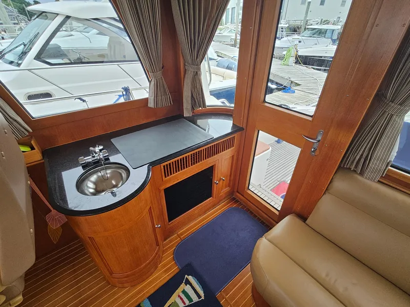 Slide: The Image of Interior of 2007 Grand Banks 39 Eastbay SX yacht with sink and seating area. - 10