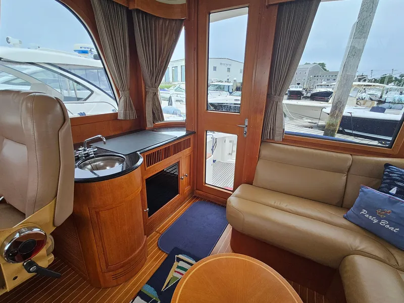 Slide: The Image of Interior of 2007 Grand Banks 39 Eastbay SX yacht with wood finish and seating area. - 11