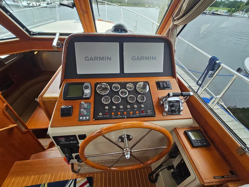 Slide: The Image of 2007 Grand Banks 39 Eastbay SX helm with Garmin navigation displays and classic wooden steering wheel. - 14