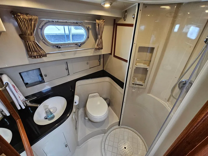 Slide: The Image of Luxurious 2007 Grand Banks 39 Eastbay SX yacht bathroom with shower and porthole window. - 17
