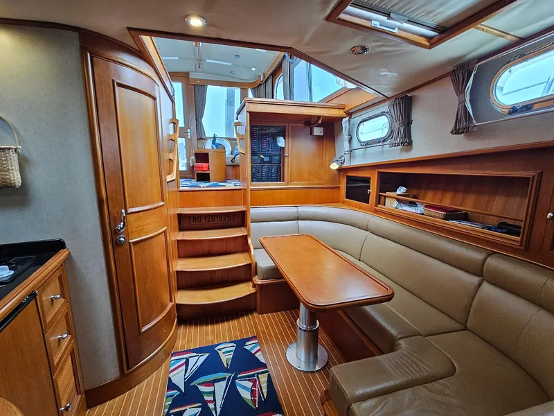 Slide: The Image of Interior of 2007 Grand Banks 39 Eastbay SX yacht with wood finish and seating area. - 18