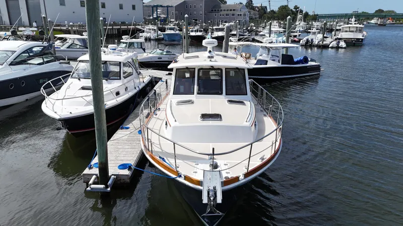 Slide: The Image of 2007 Grand Banks 39 Eastbay SX docked at a marina with other boats. - 2