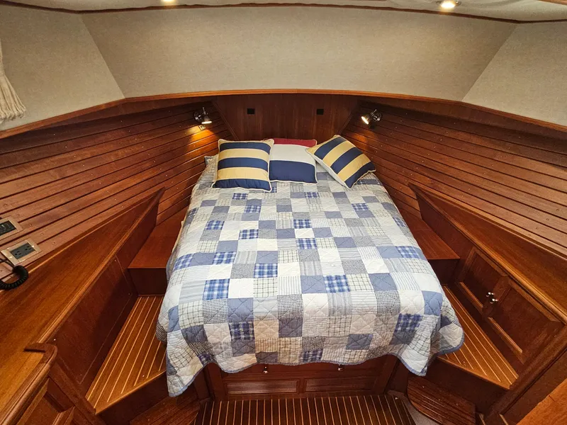 Slide: The Image of Cozy cabin interior of 2007 Grand Banks 39 Eastbay SX with quilted bed and wooden paneling. - 22