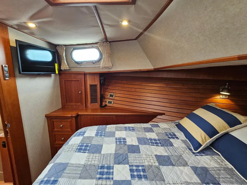 Slide: The Image of Cozy cabin interior of 2007 Grand Banks 39 Eastbay SX with bed and TV. - 23